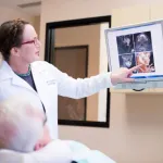 Dr. Geisler showing a patient xrays