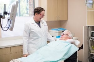 Dental Implants Specialist, Dr. Geisler, helping a patient